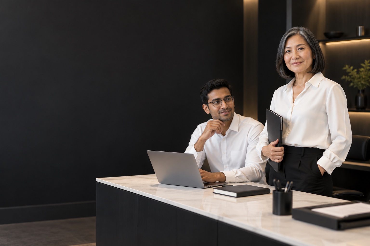 Back Office — professional in a warm charcoal and white workspace