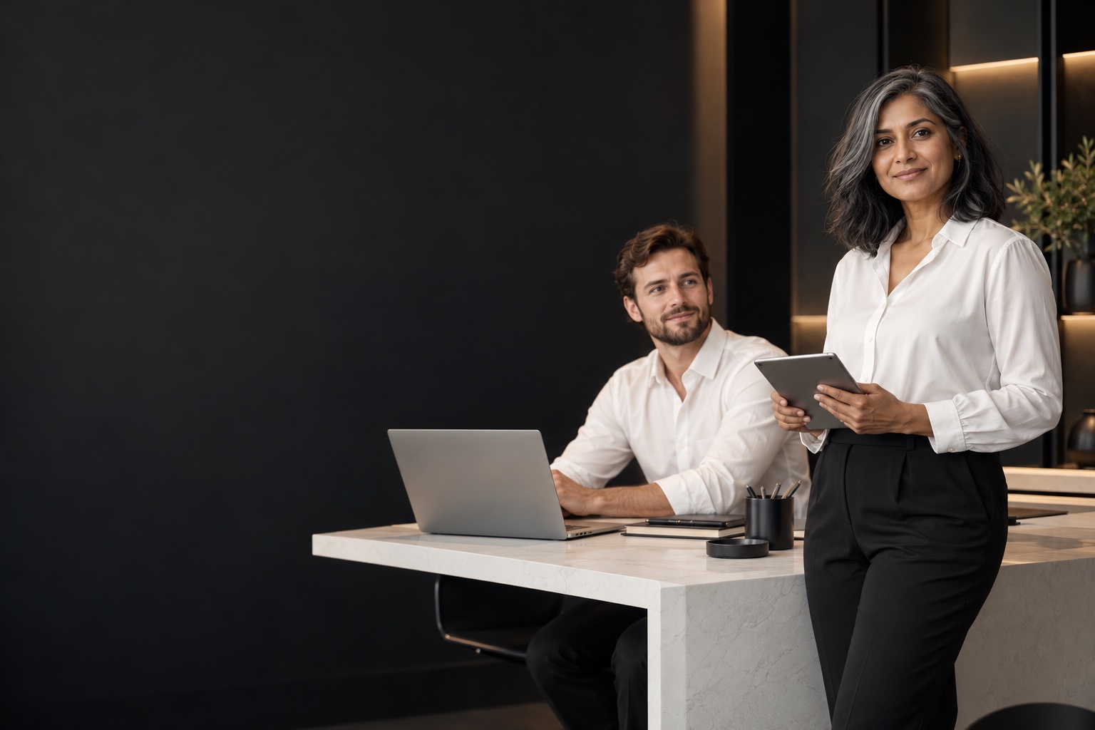 IT & Technical Support — professional in a warm charcoal and white workspace